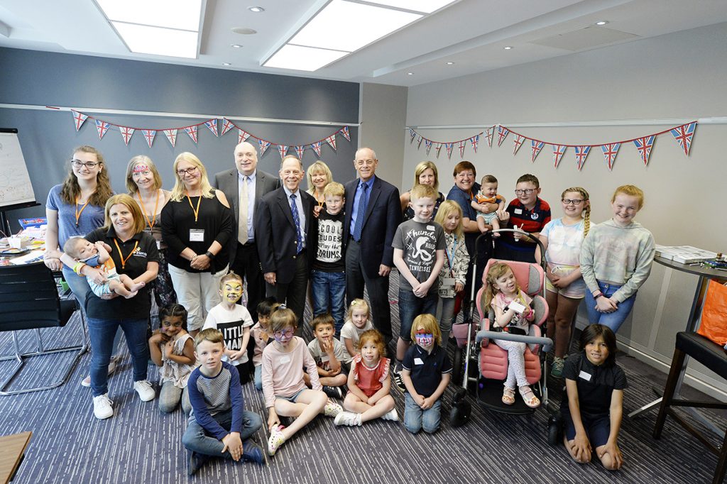 group photo of children and adults at conference